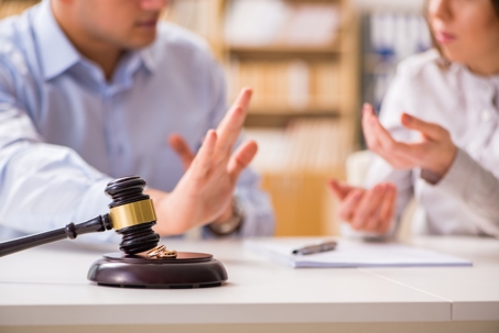 Man and Woman arguing next to gavel